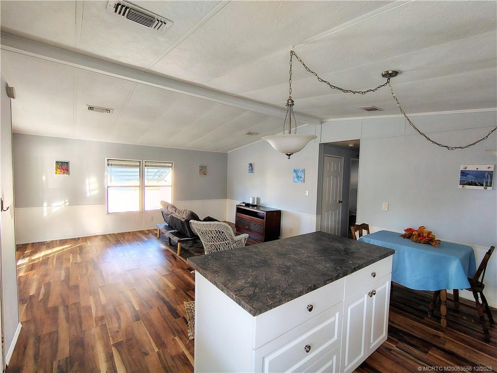 2581 Southwest Pontiac Place Stuart, FL 34997 - Photo 17 of 62 a open kitchen with stainless steel appliances granite countertop a stove and a wooden floors