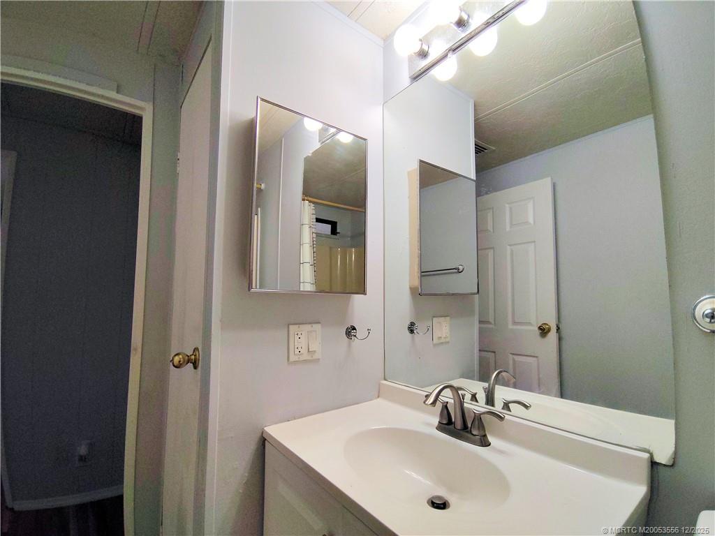 2581 Southwest Pontiac Place Stuart, FL 34997 - Photo 31 of 62 a bathroom with a sink and a mirror