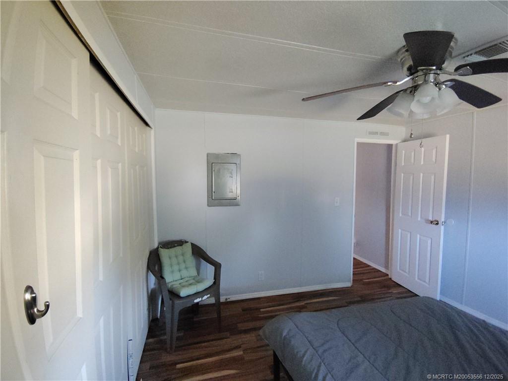 2581 Southwest Pontiac Place Stuart, FL 34997 - Photo 36 of 62 a bedroom with a bed and a chandelier