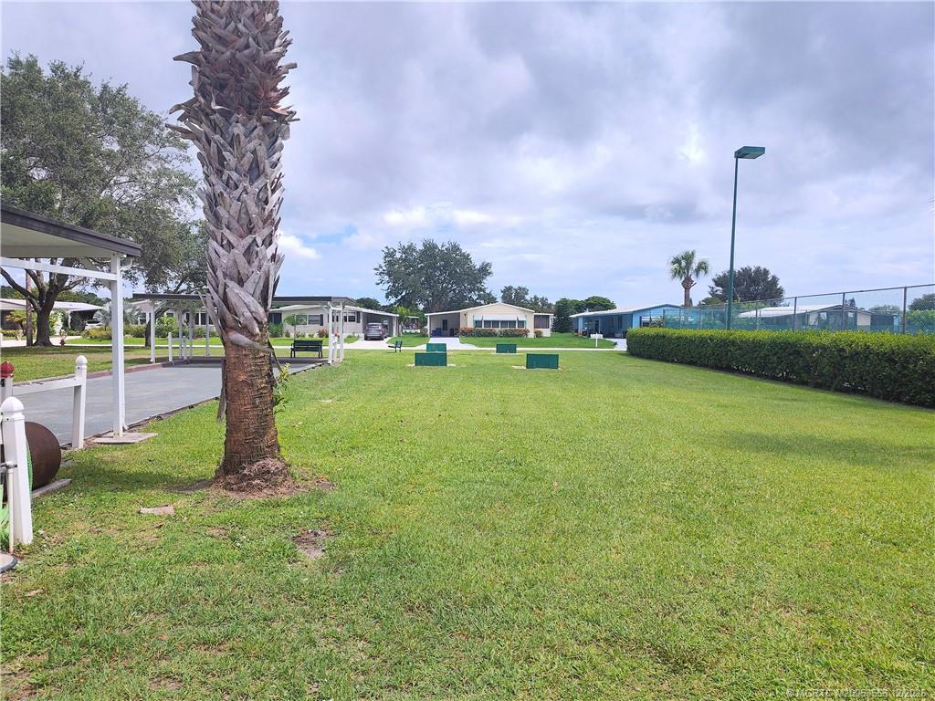 2581 Southwest Pontiac Place Stuart, FL 34997 - Photo 50 of 62 a swimming pool with outdoor seating and yard