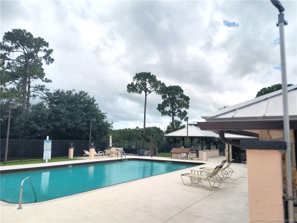 2581 Southwest Pontiac Place Stuart, FL 34997 - Photo 54 of 62 a view of a swimming pool with a patio and couches