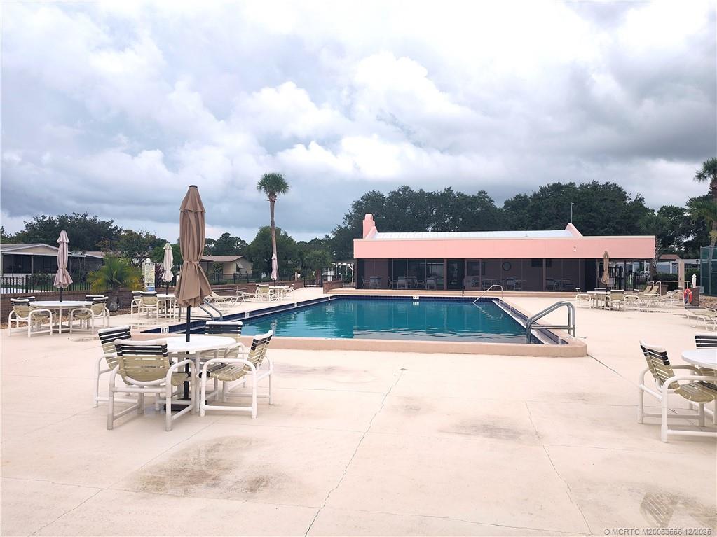 2581 Southwest Pontiac Place Stuart, FL 34997 - Photo 56 of 62 a view of a swimming pool with outdoor seating and plants