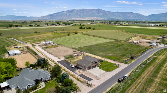 5702 950 North Ogden, UT 84404 - Photo 8 of 36 Expansive rural property featuring a large barn, a fenced equestrian arena, and an open field