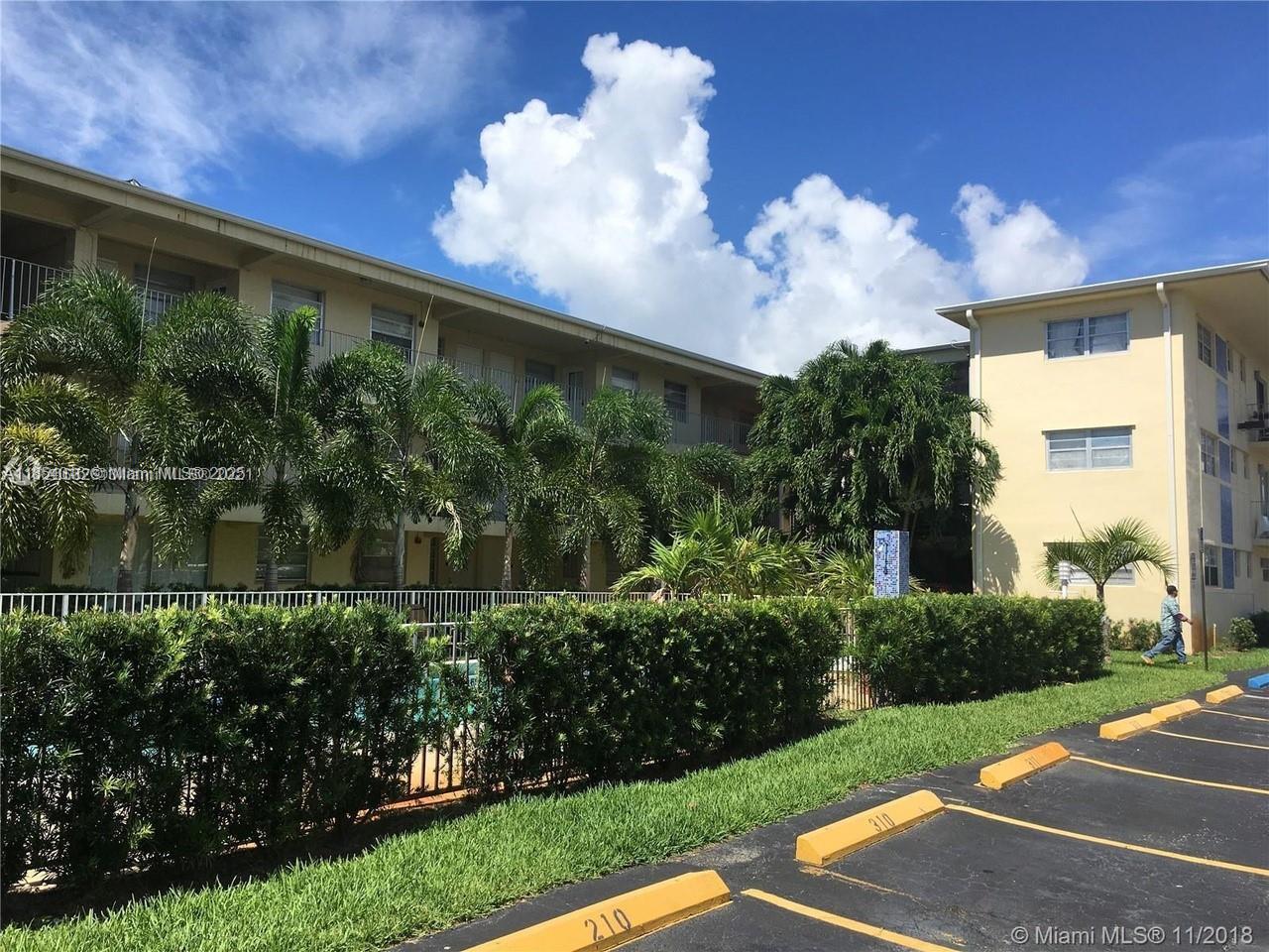 1100 Northeast 1st Court, Unit 102 Hallandale Beach, FL 33009 - Photo 2 of 3 a view of a fountain in front of a house