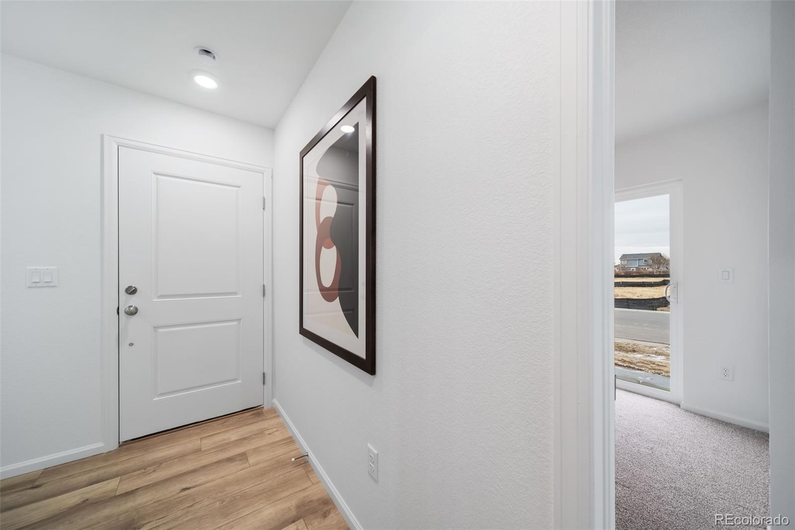 3372 Baltin Road Johnstown, CO 80534 - Photo 20 of 24 an empty room with wooden floor closet and windows