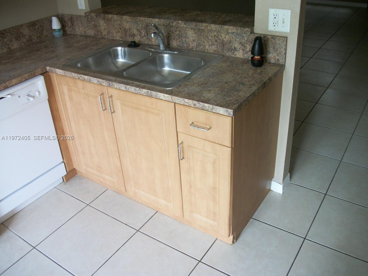 136 Southwest 15th Terrace Homestead, FL 33030 - Photo 13 of 37 a kitchen with granite countertop a sink and a stove