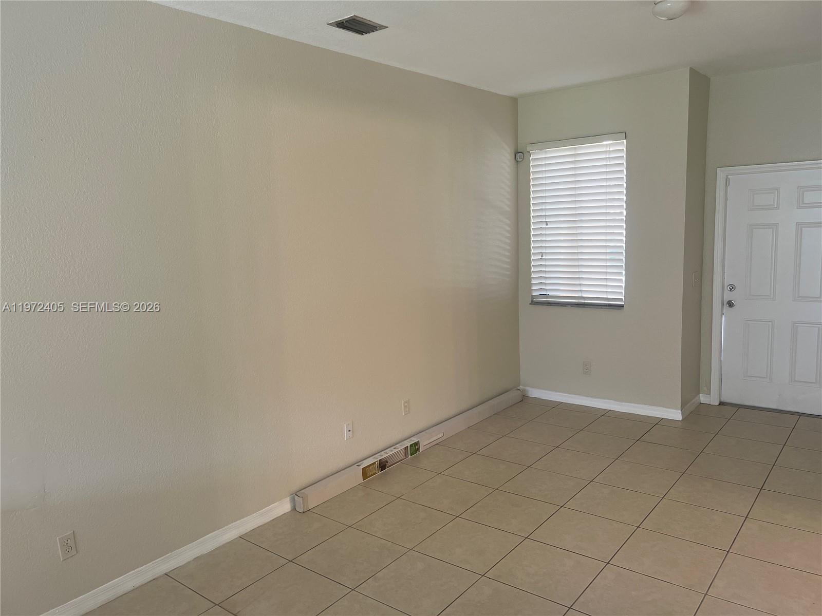 136 Southwest 15th Terrace Homestead, FL 33030 - Photo 15 of 37 an empty room with windows