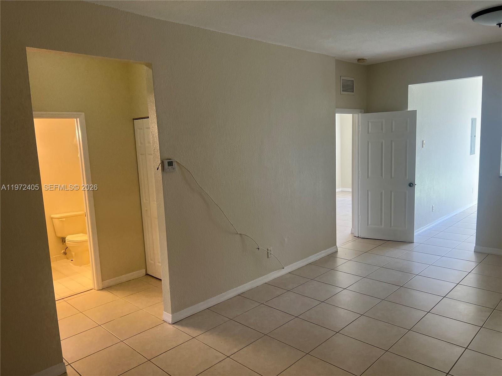 136 Southwest 15th Terrace Homestead, FL 33030 - Photo 17 of 37 a view of a hallway with a door
