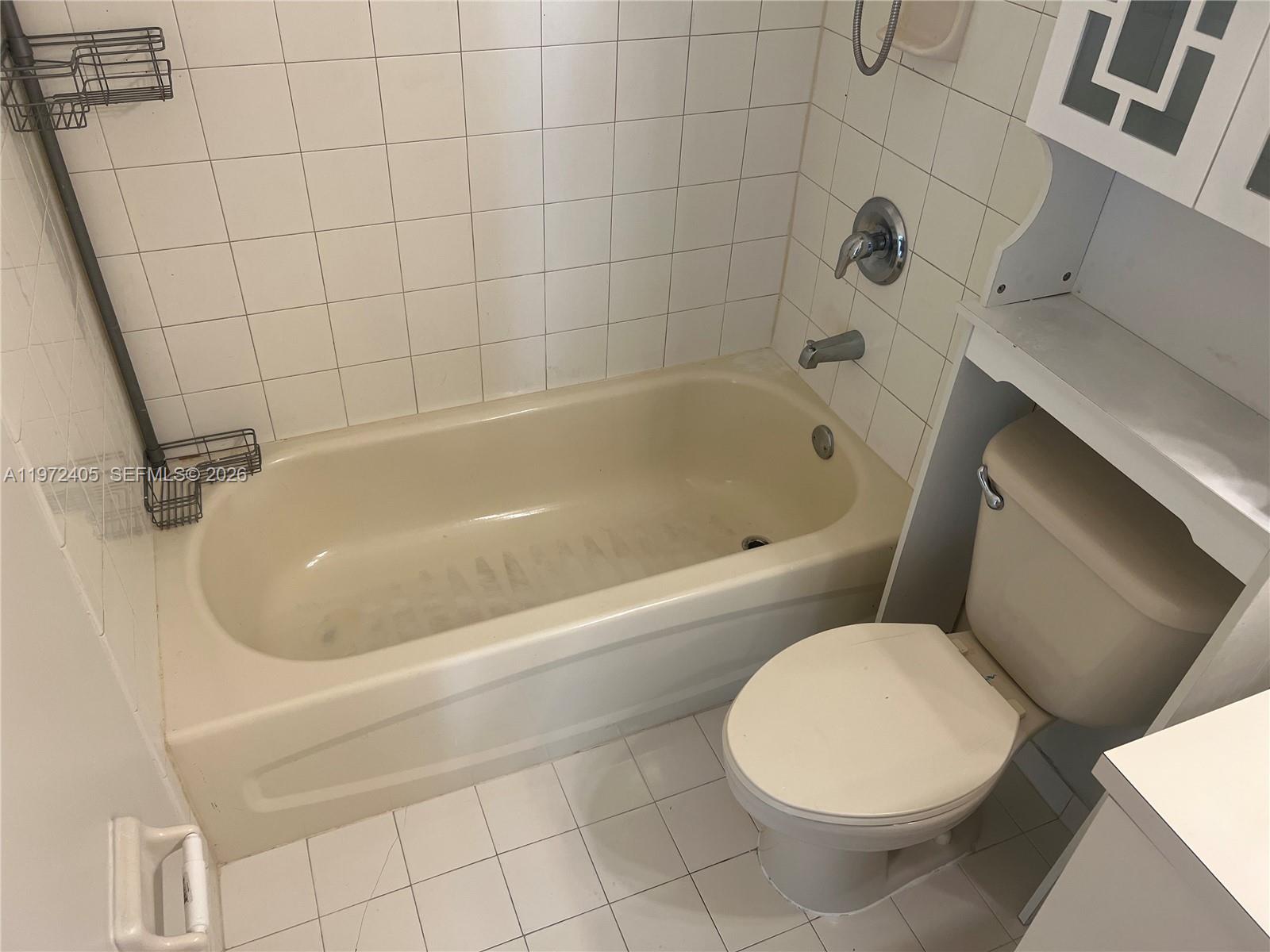 136 Southwest 15th Terrace Homestead, FL 33030 - Photo 25 of 37 a white bath tub sitting next to a white toilet and sink