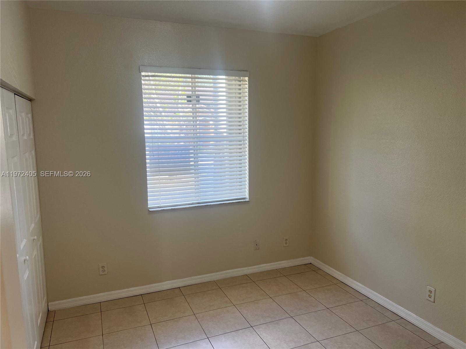 136 Southwest 15th Terrace Homestead, FL 33030 - Photo 28 of 37 an empty room with a window