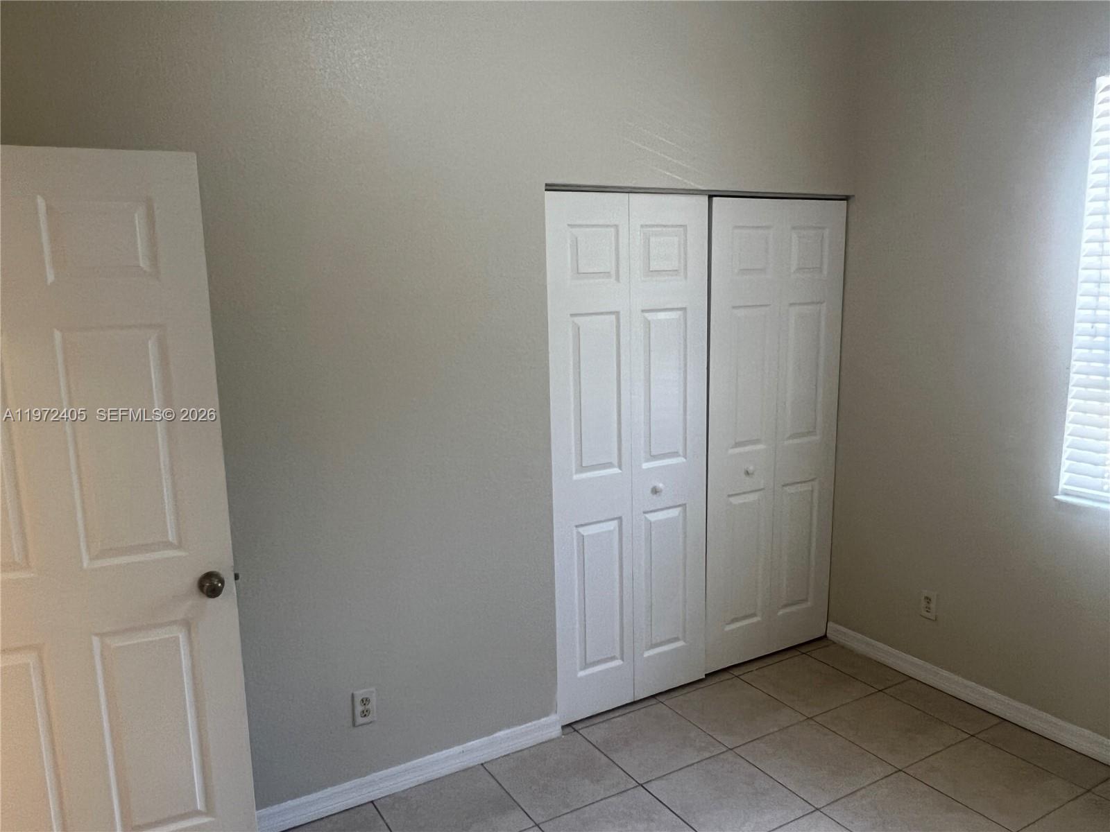 136 Southwest 15th Terrace Homestead, FL 33030 - Photo 31 of 37 an empty room with windows