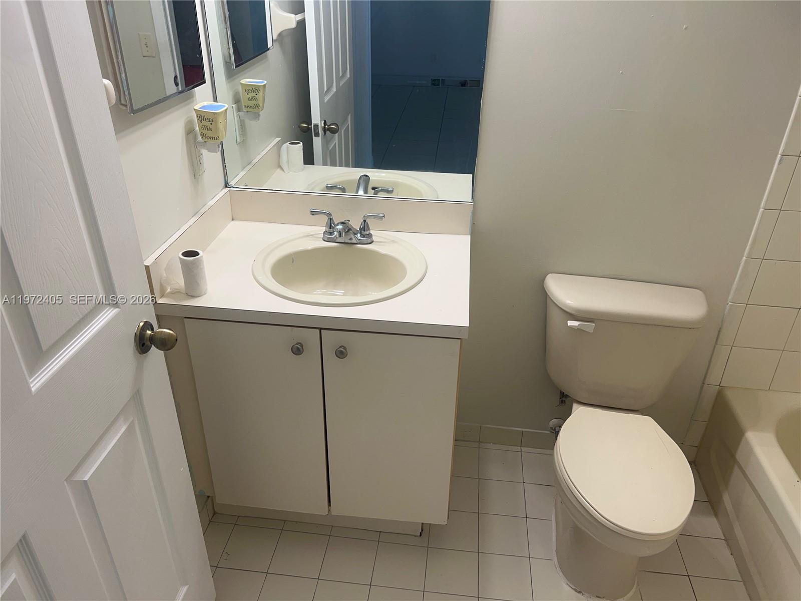 136 Southwest 15th Terrace Homestead, FL 33030 - Photo 36 of 37 a bathroom with a toilet sink and mirror