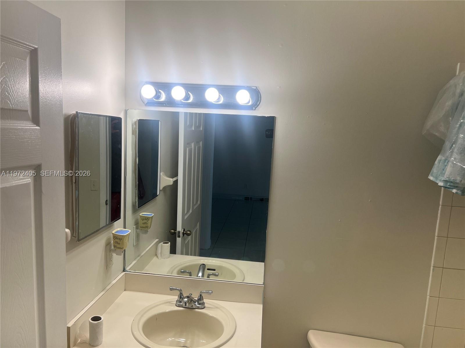 136 Southwest 15th Terrace Homestead, FL 33030 - Photo 37 of 37 a bathroom with a sink and a mirror