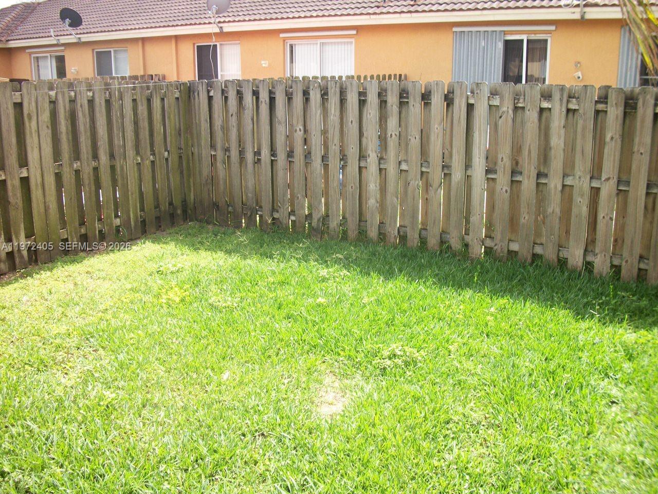 136 Southwest 15th Terrace Homestead, FL 33030 - Photo 5 of 37 a view of a backyard with potted plants