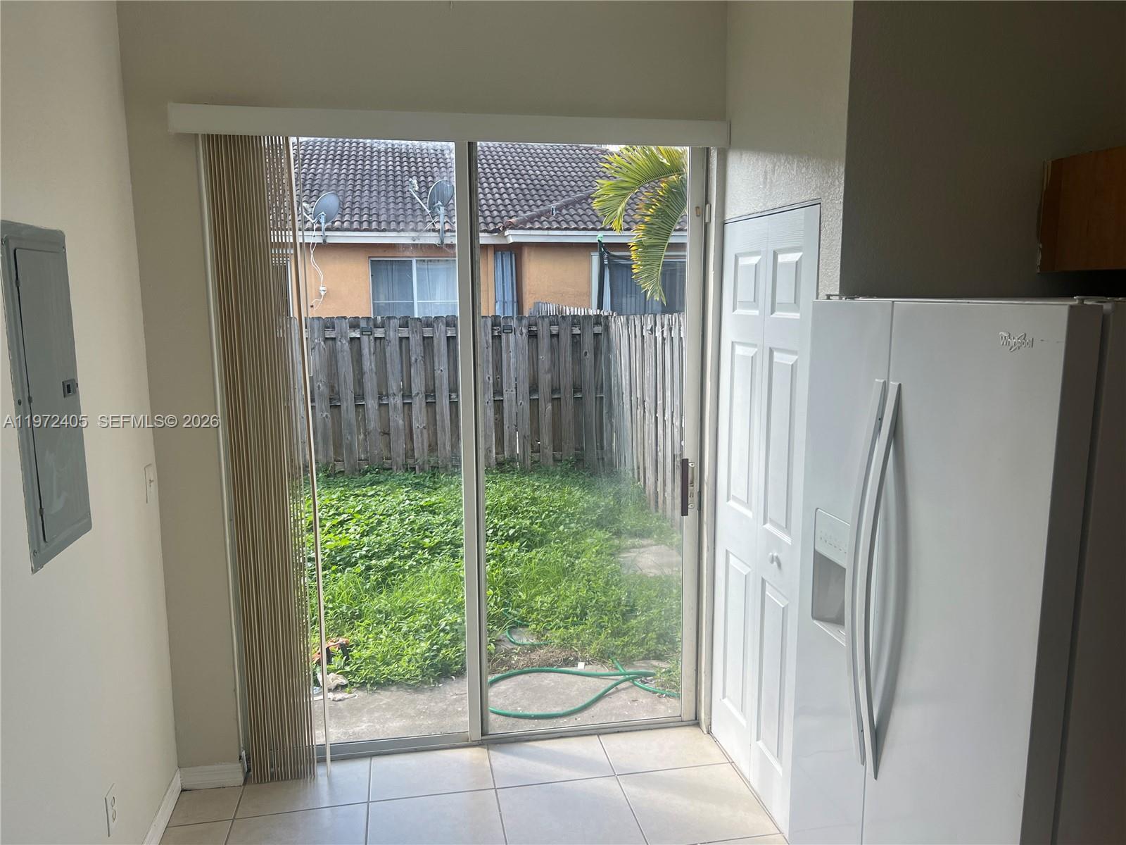 136 Southwest 15th Terrace Homestead, FL 33030 - Photo 9 of 37 a view of a back yard from a hallway