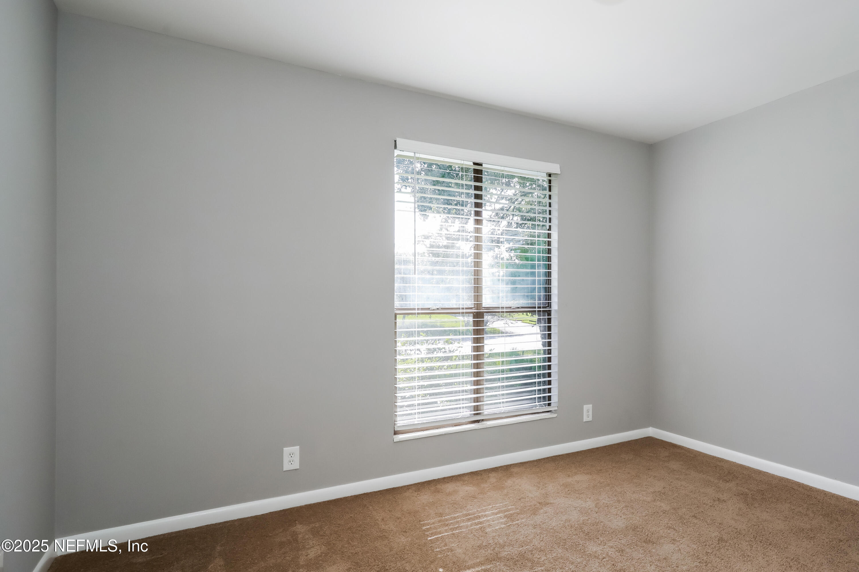 8408 Rampart Road Jacksonville, FL 32244 - Photo 12 of 15 a view of an empty room with a window
