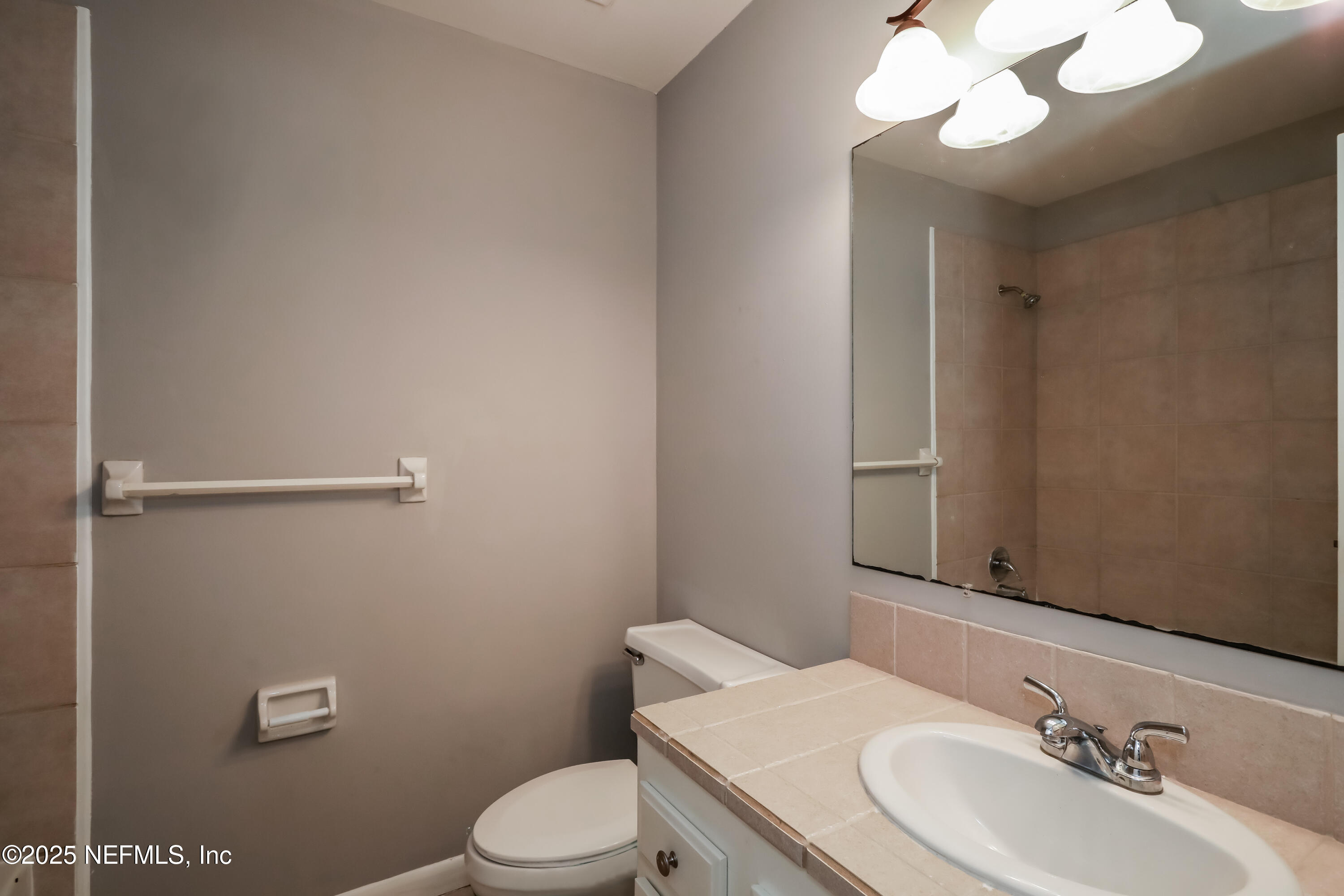 8408 Rampart Road Jacksonville, FL 32244 - Photo 13 of 15 a bathroom with a sink vanity mirror and toilet