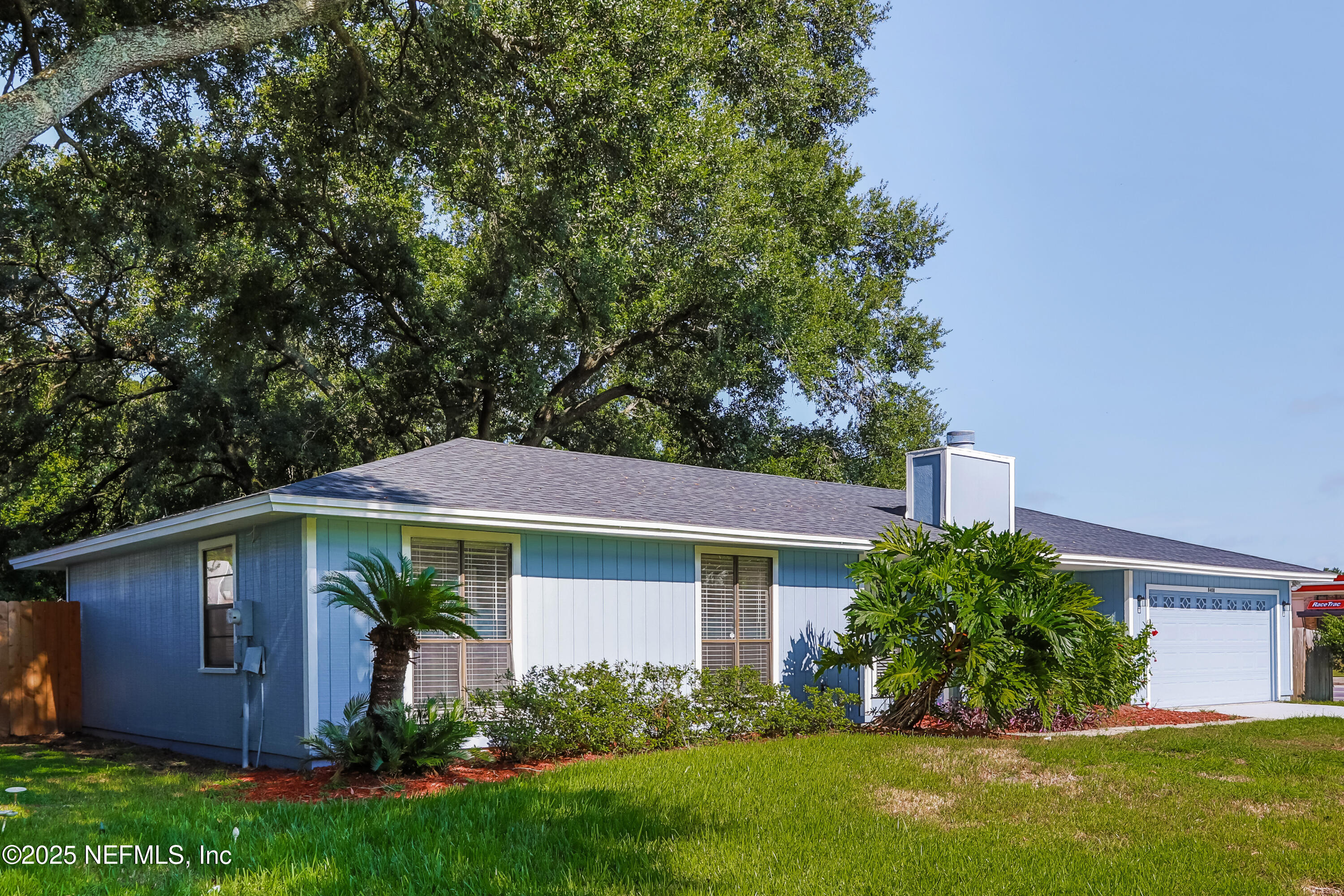 8408 Rampart Road Jacksonville, FL 32244 - Photo 2 of 15 a view of a yard in front of a house with plants and large tree