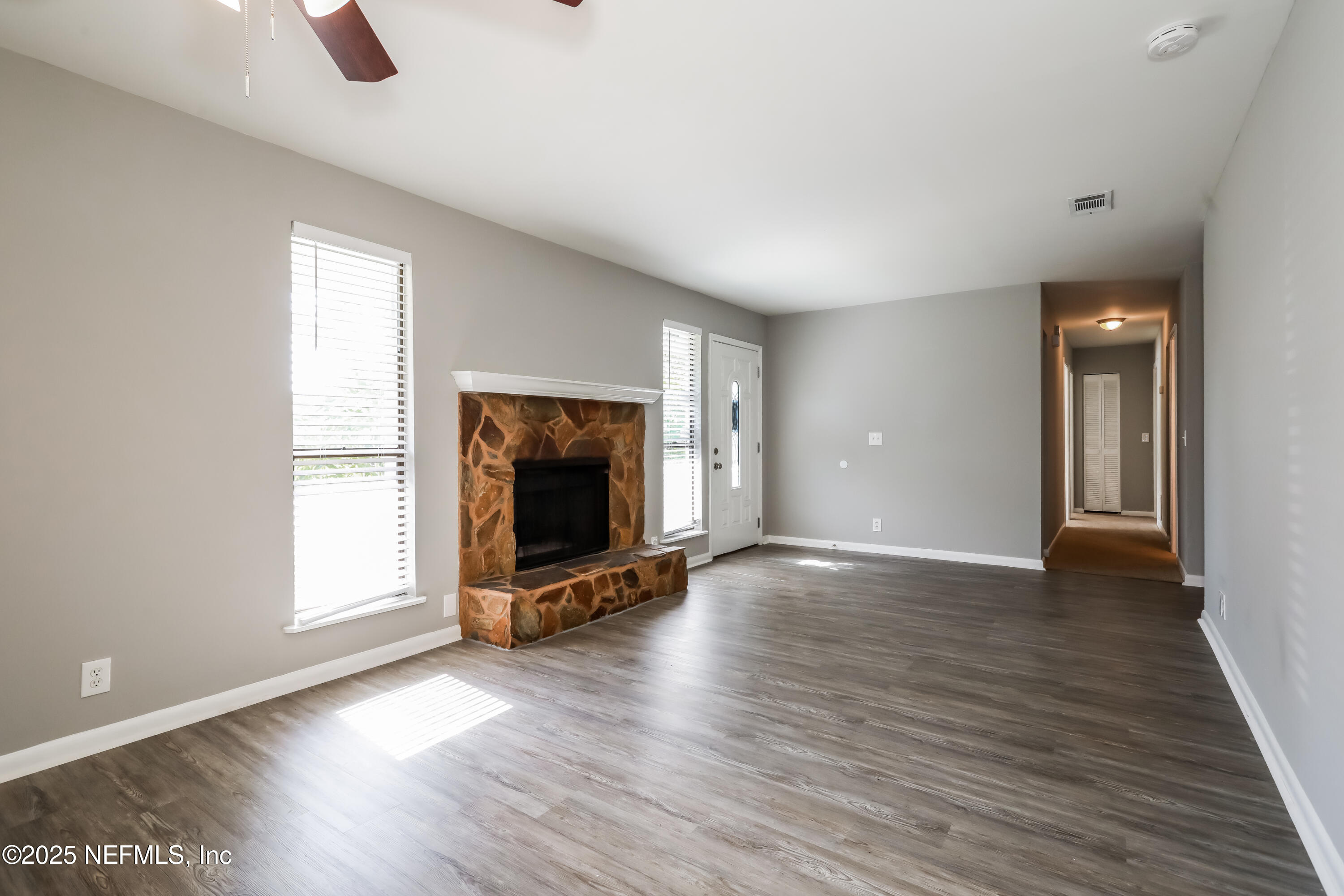 8408 Rampart Road Jacksonville, FL 32244 - Photo 4 of 15 a view of an empty room with window and wooden floor