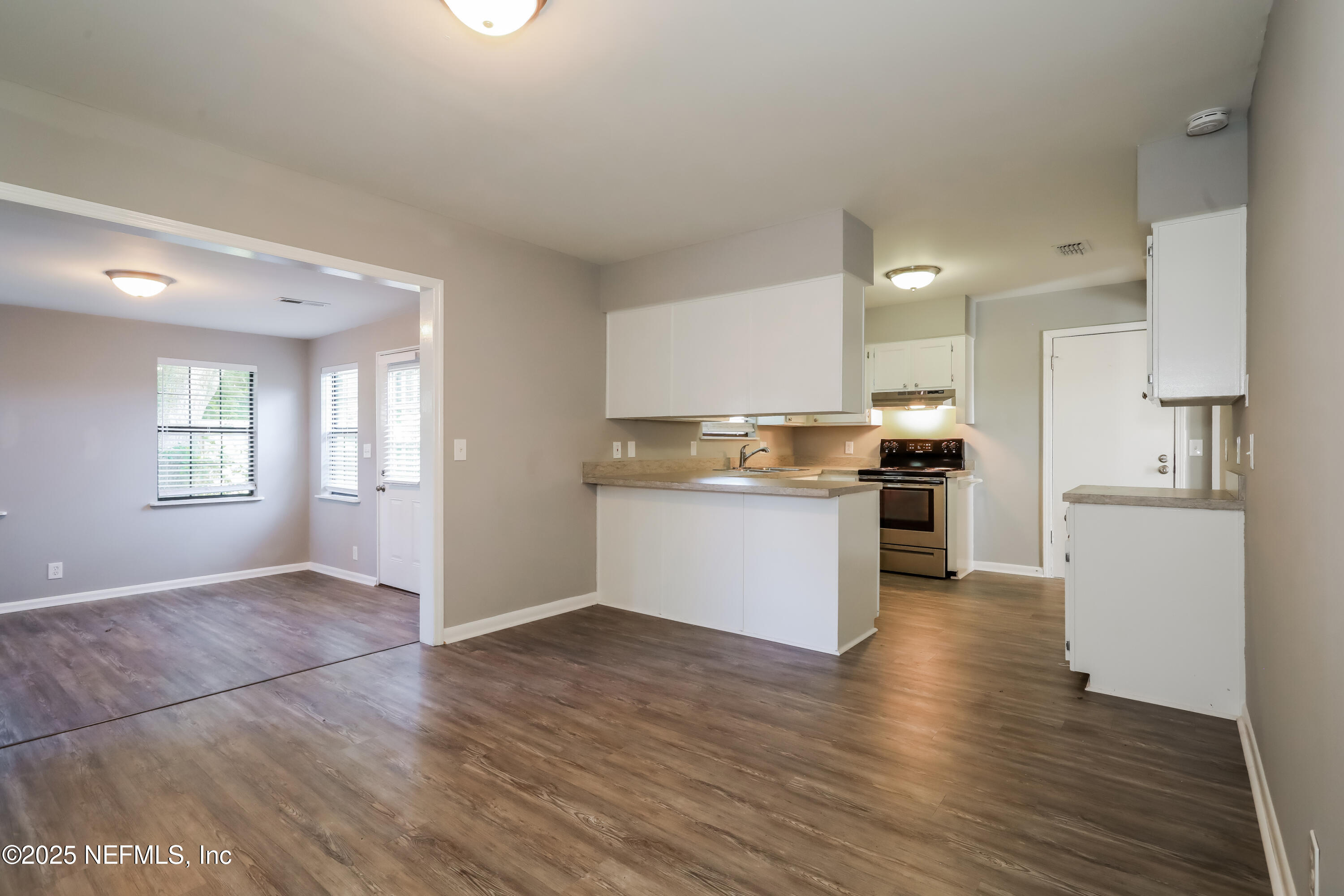 8408 Rampart Road Jacksonville, FL 32244 - Photo 5 of 15 a kitchen with a refrigerator and a stove top oven