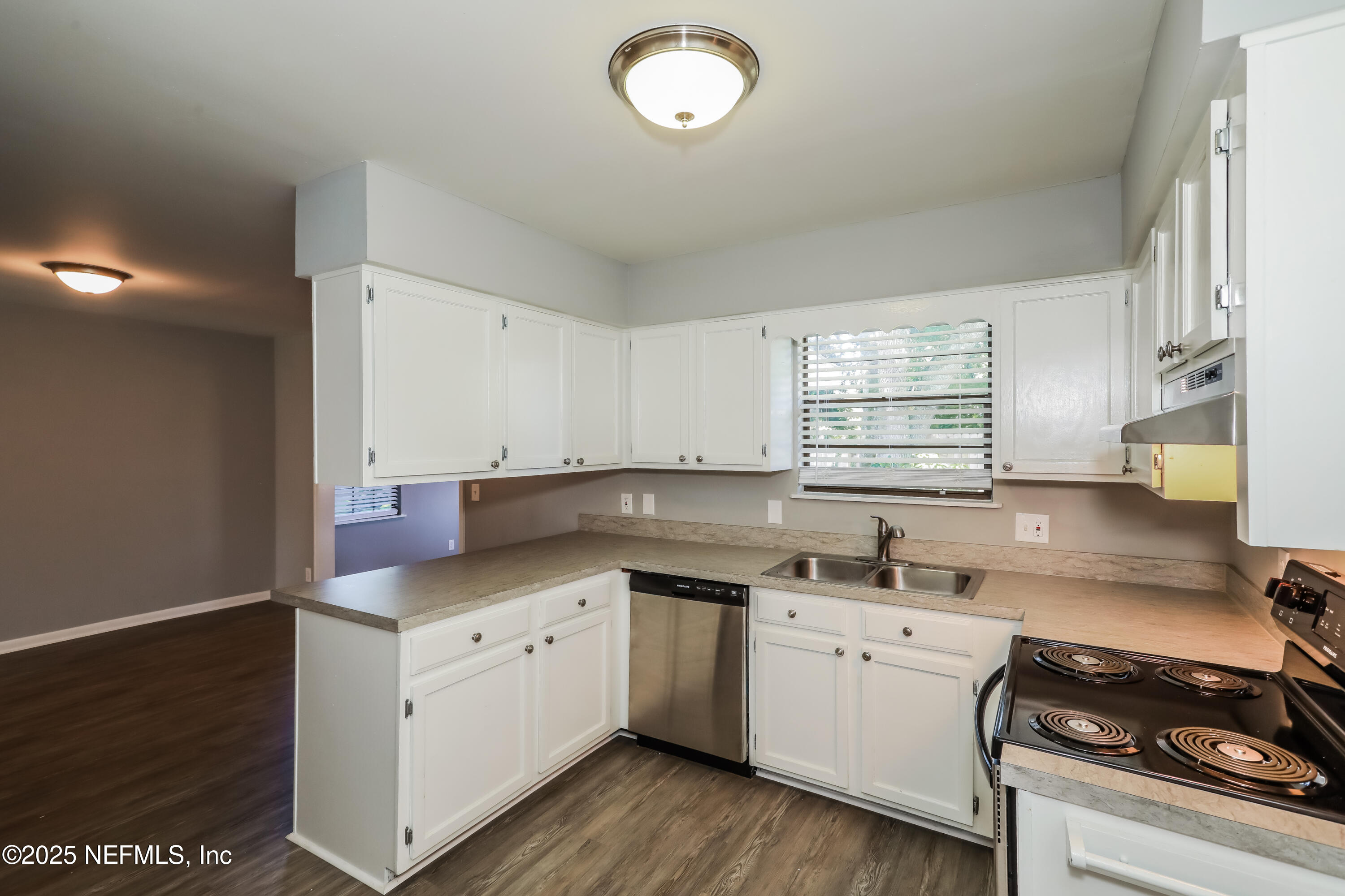 8408 Rampart Road Jacksonville, FL 32244 - Photo 7 of 15 a kitchen with a sink stove and cabinets