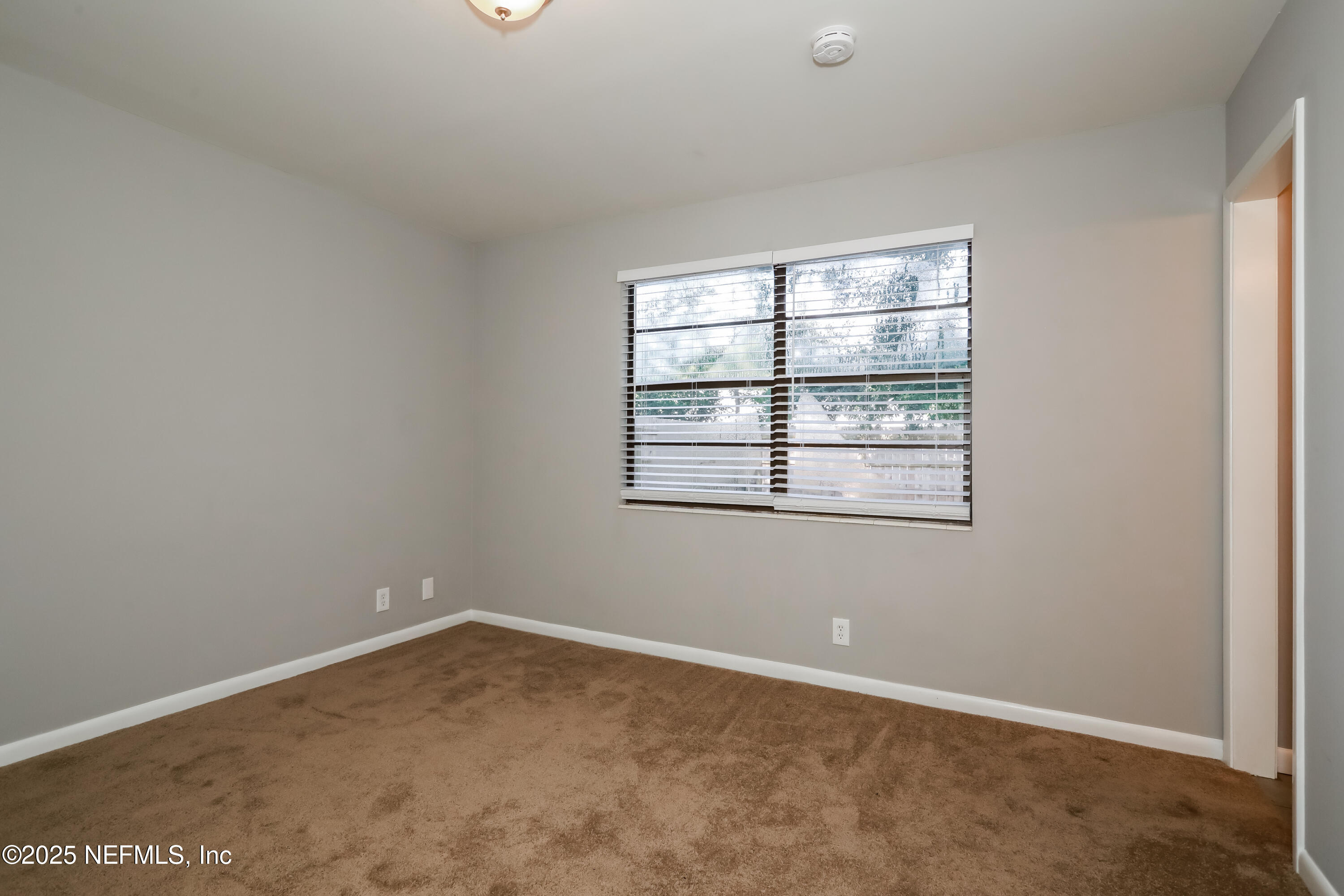 8408 Rampart Road Jacksonville, FL 32244 - Photo 9 of 15 an empty room with a window