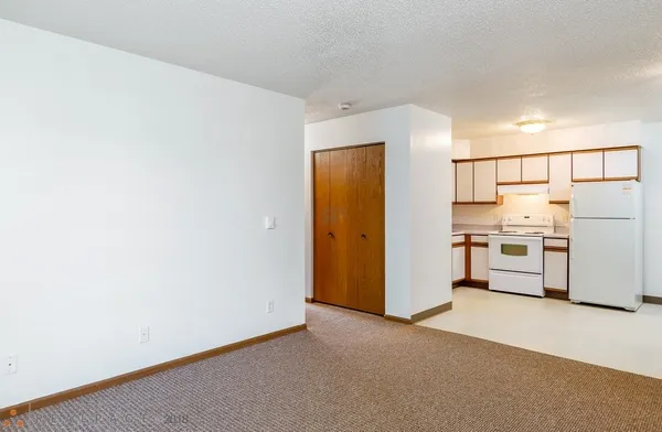 a view of a kitchen with a sink and a refrigerator