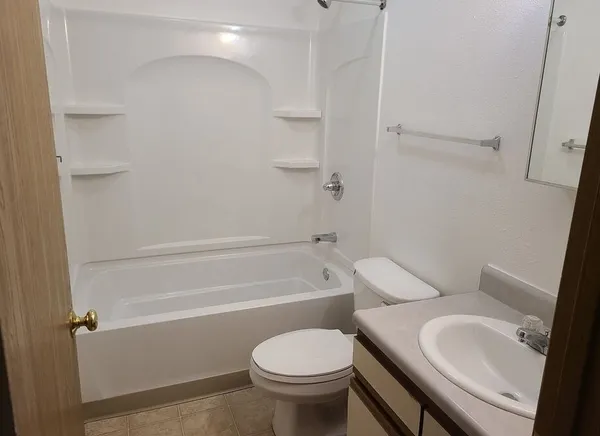 a bathroom with a toilet sink and shower