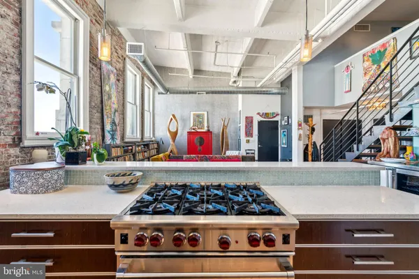 a kitchen with stove and cabinets