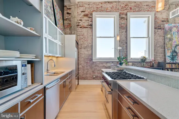 a kitchen with stainless steel appliances granite countertop a sink stove and cabinets