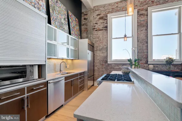 a kitchen with granite countertop a stove and a microwave