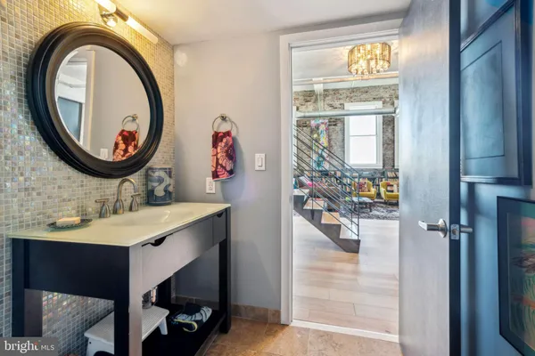 a bathroom with a sink a mirror and a window