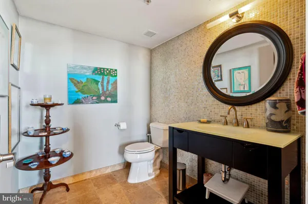a bathroom with a toilet a sink and a mirror
