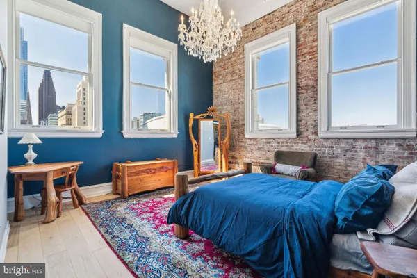 a bedroom with furniture and a chandelier