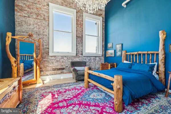 a bedroom with furniture and a rug