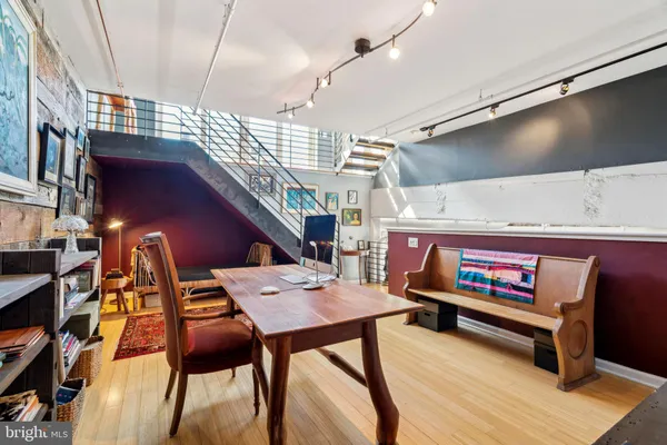 a living room with furniture a rug and a window