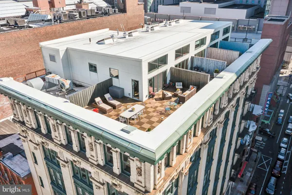 a roof deck with table and chairs