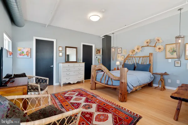 a bedroom with a bed and balcony view