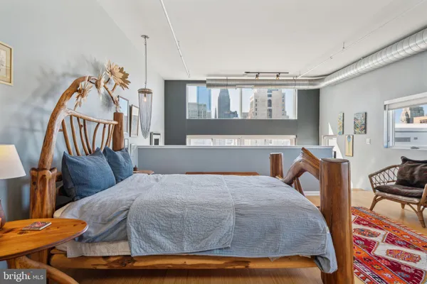 a bedroom with furniture and a wooden floor