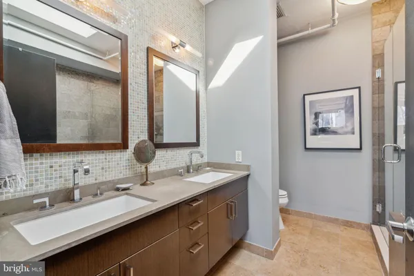 a bathroom with a double vanity sink and a mirror