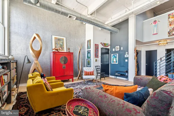a living room with furniture a rug and a large window