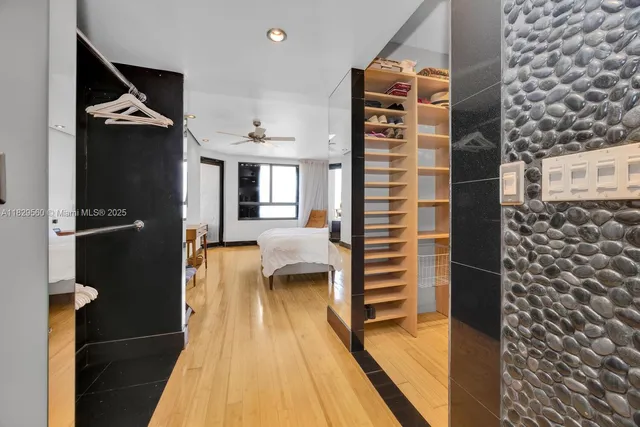 a view of walk in closet and bathroom