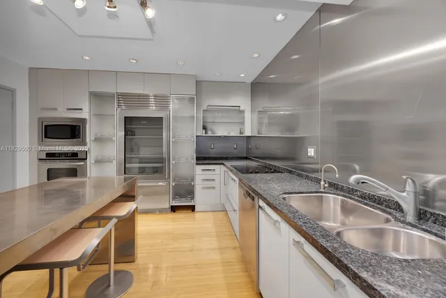 a kitchen filled counter top space a sink and appliances