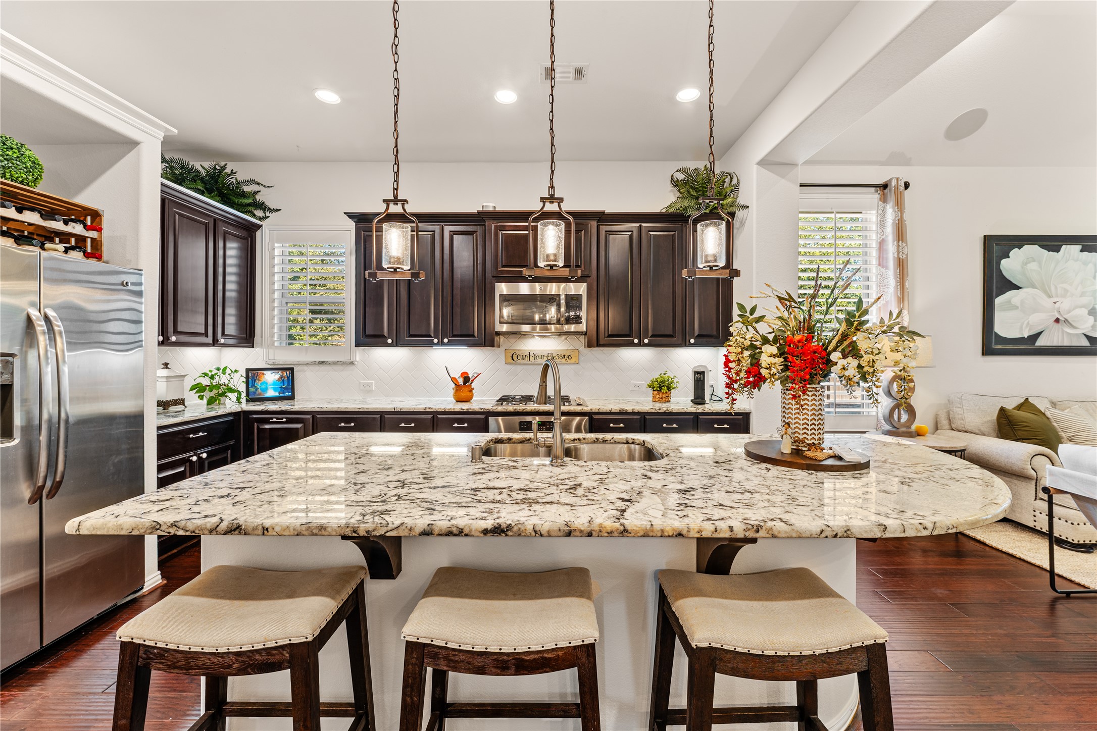 6014 Barrett Cove Court Richmond, TX 77407 - Photo 15 of 45 a kitchen with kitchen island granite countertop a table and chairs in it