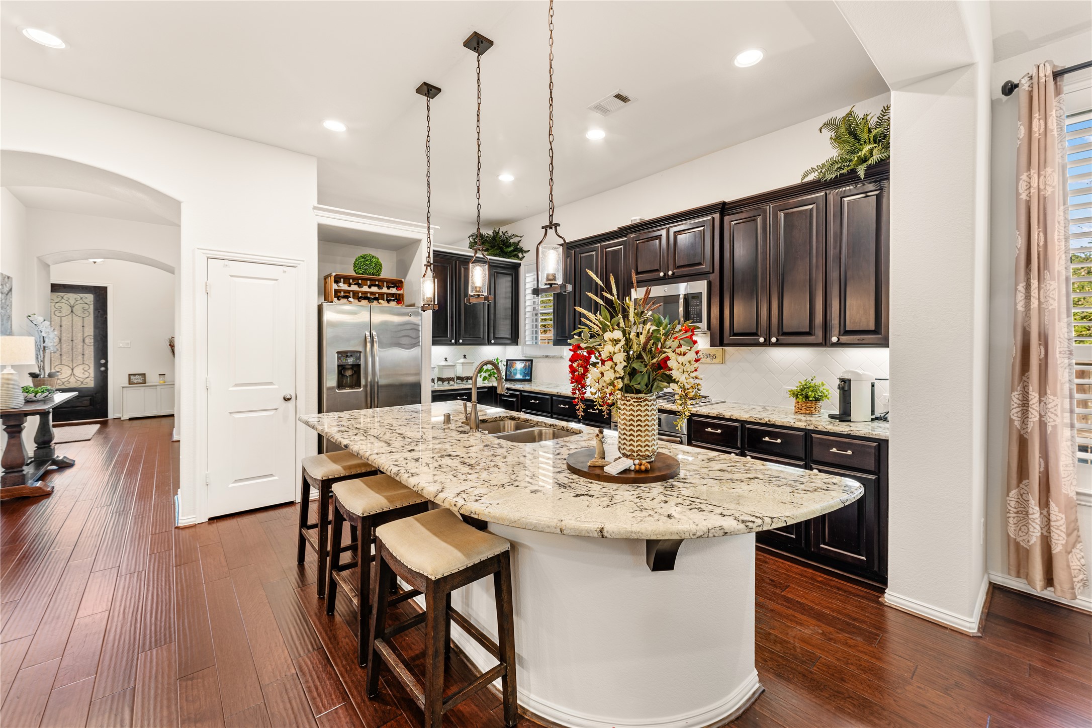 6014 Barrett Cove Court Richmond, TX 77407 - Photo 17 of 45 a kitchen with a table chairs refrigerator and microwave