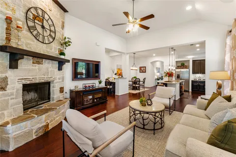 a living room with furniture a fireplace and a flat screen tv