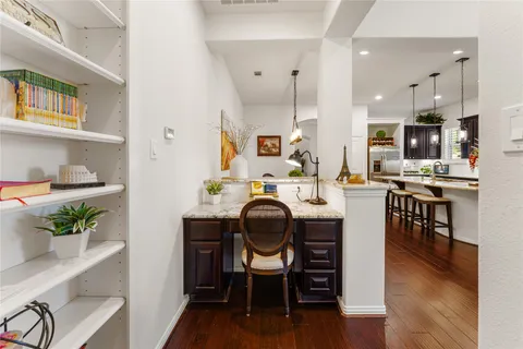 a living room with furniture a dining table wooden floor and kitchen view