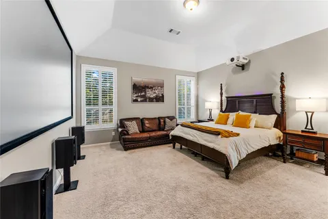 a spacious bedroom with a bed and a window