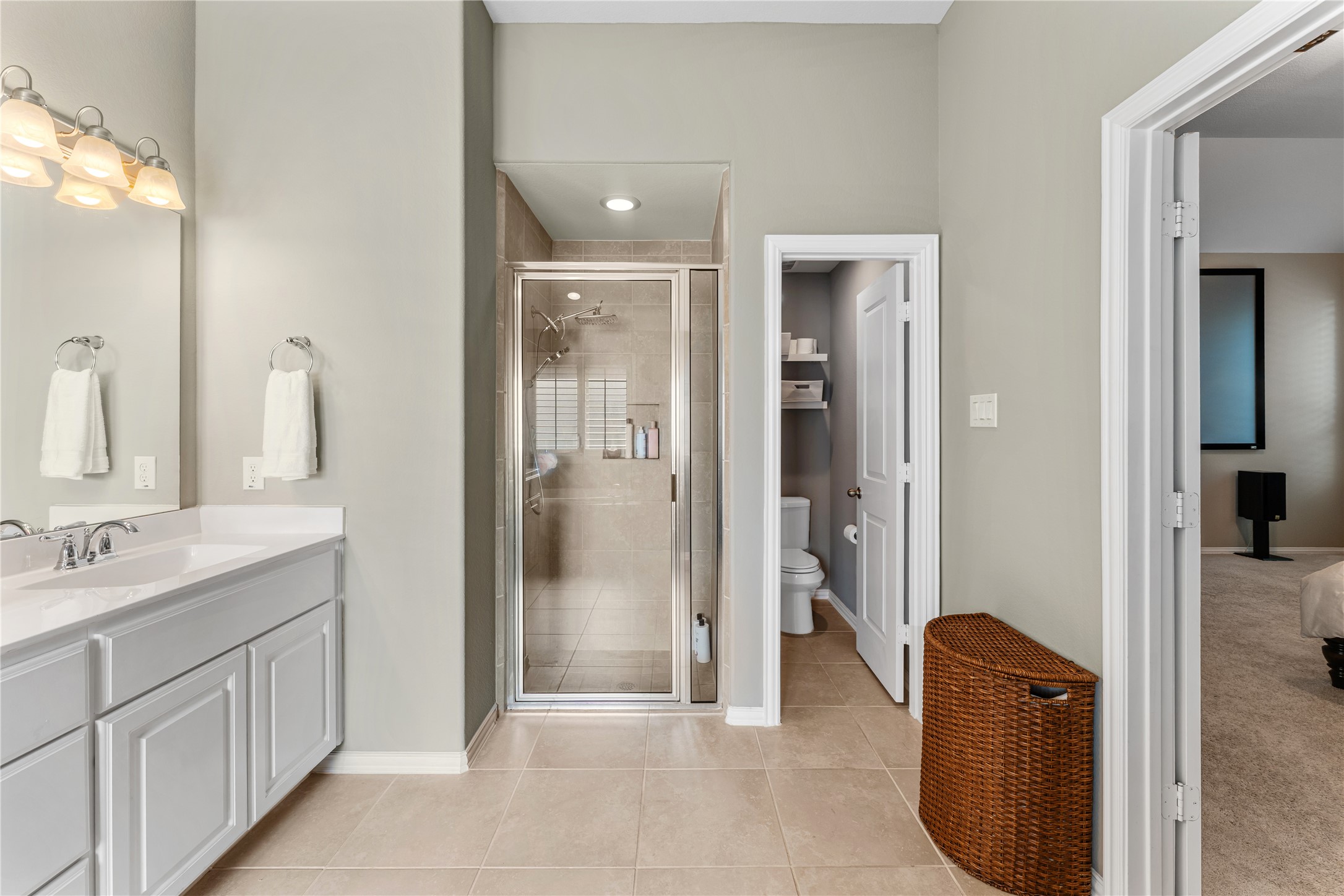 6014 Barrett Cove Court Richmond, TX 77407 - Photo 30 of 45 a bathroom with a double vanity sink a mirror and a shower