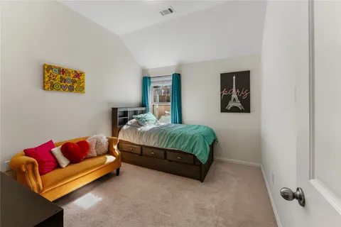 a bedroom with a bed and couch